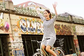 Woman on a bike on the riverside of the Donaukanal